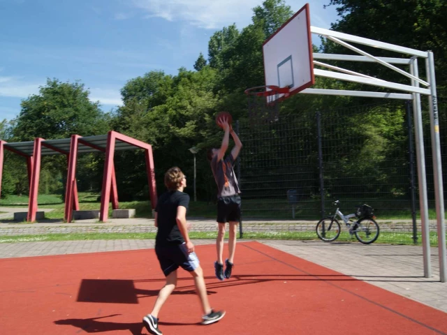 Boy goes for a layup in on on one streetball match
