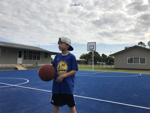 Milo hooping on the blue court in New Zealand