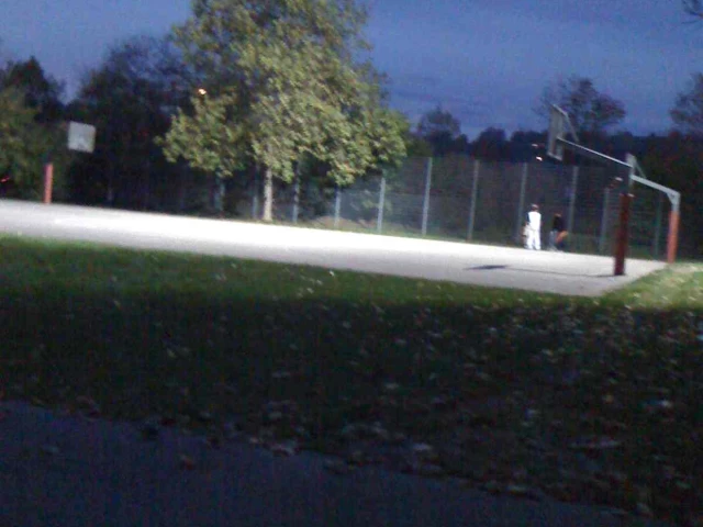 The basketball courts at night.