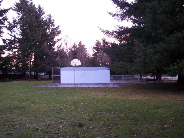In somewhat hidden park adjoining a school lies this court.